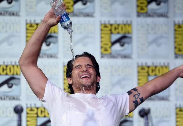 A person pouring water over his face