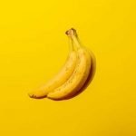 two bananas on a yellow background