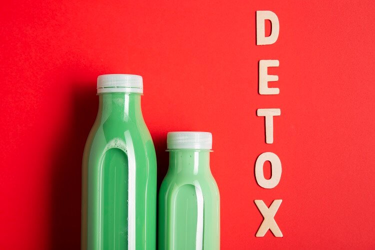 two bottles with green juice and the word detox in vertical format