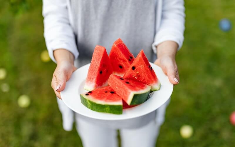 A plate filled with sliced watermelons