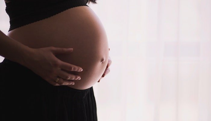 closeup of a pregnant woman belly