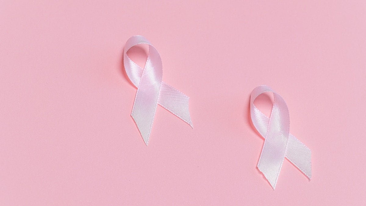 two pink ribbons on a pink background used as a featured image for cancer fighting foods