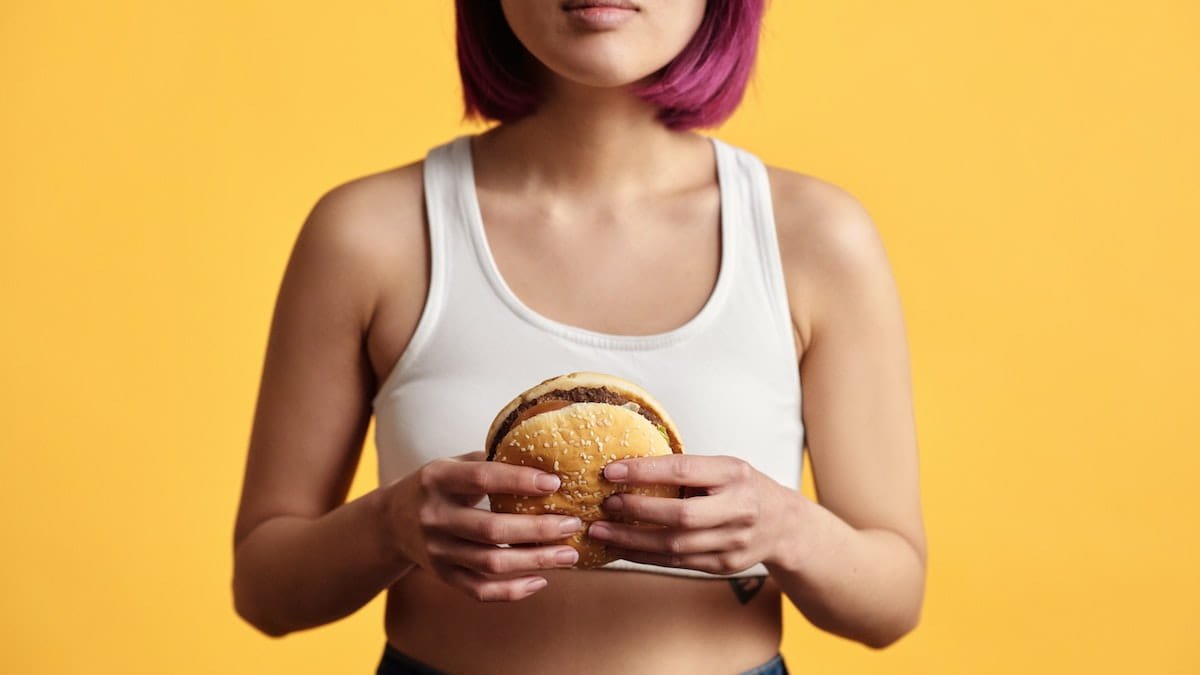 asian girl holding a burger