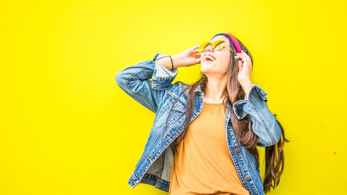 a happy girl in a yellow background