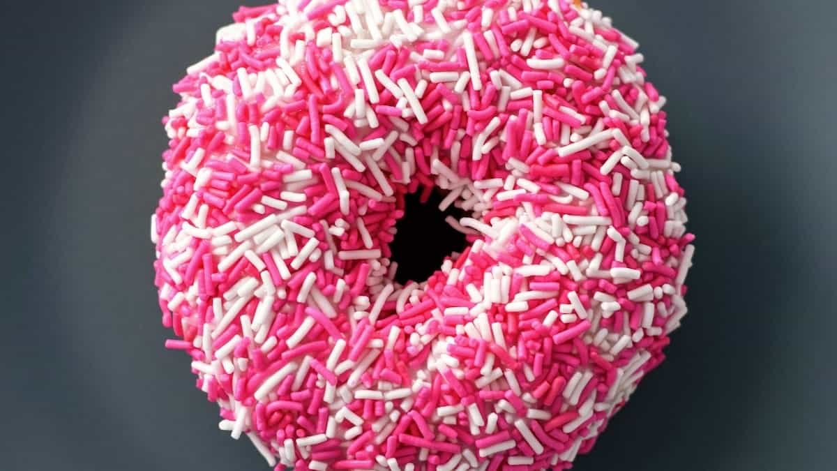 A sugary donut is the thumbnail for the post Sugar Detox Benefits