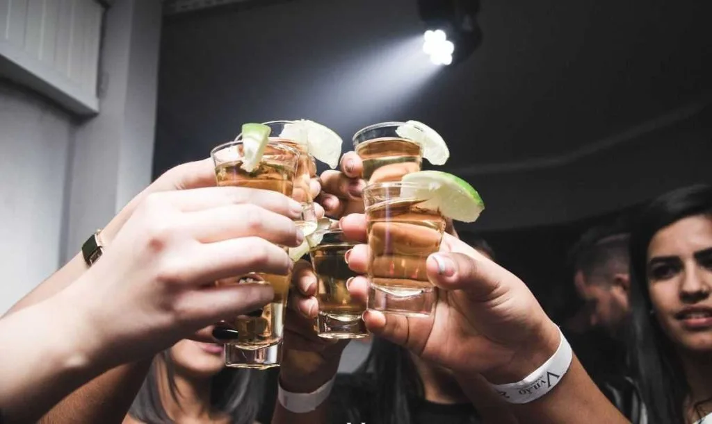 a group of people drinking shots