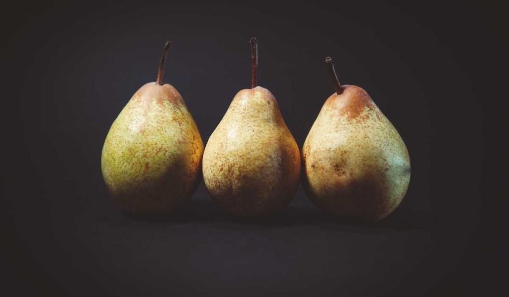 Three pears in black background