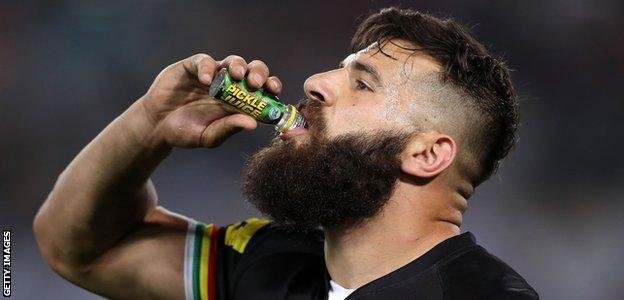 Athlete Josh Mansour drinks a shot of pickle juice during a National Rugby League match in 2017 in Sydney, Australia.