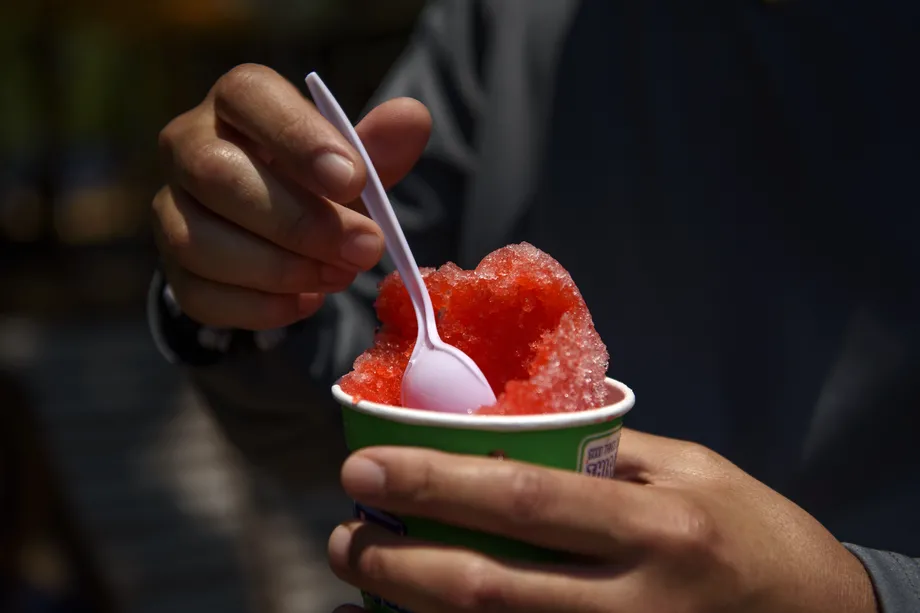 A person eating a snow cone