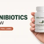 Hand holding a Cognibiotics supplement bottle with the front label visible