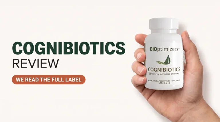 Hand holding a Cognibiotics supplement bottle with the front label visible