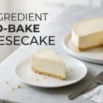 Whole no-bake cheesecake with one clean slice plated beside it, made with 5 ingredients